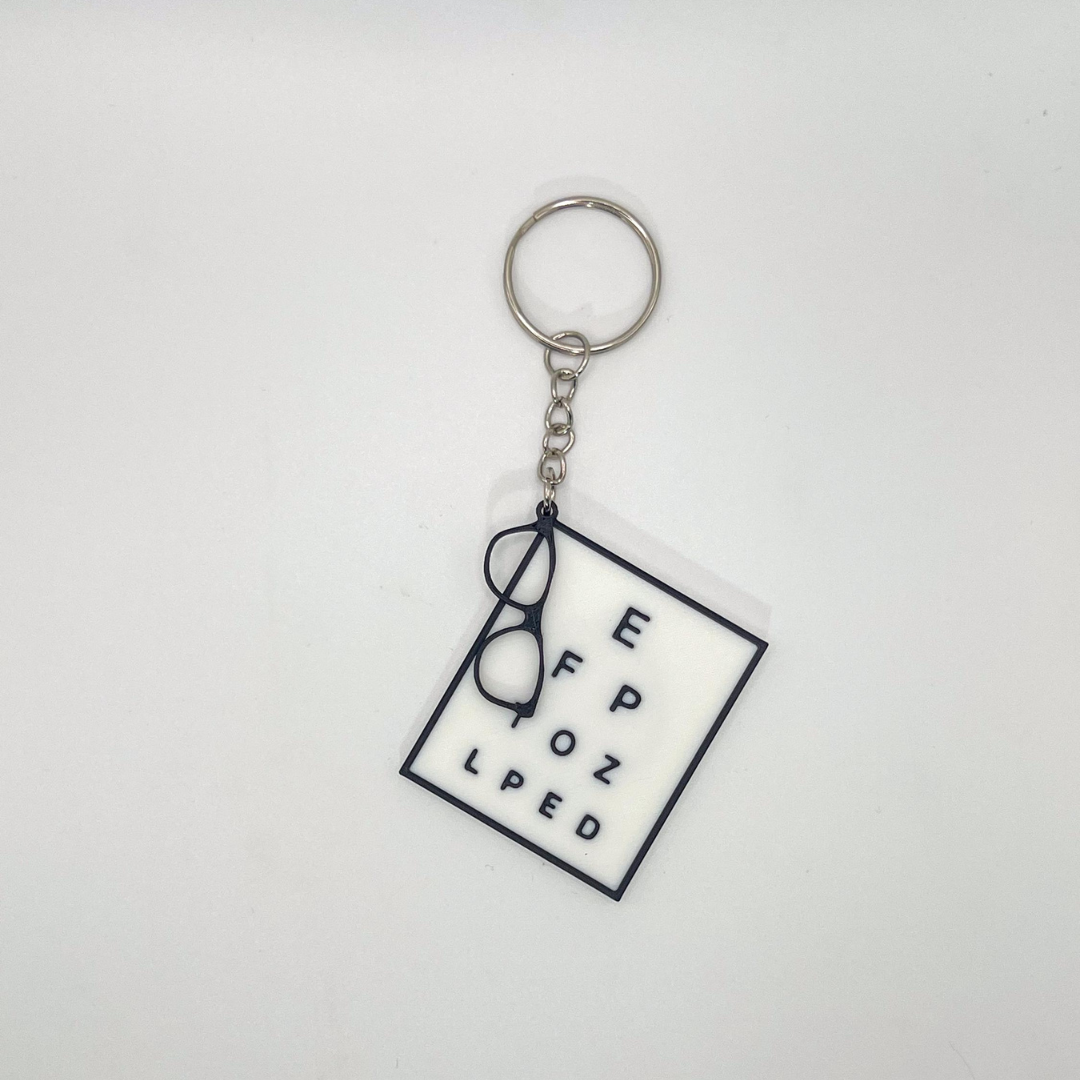 Keychain with eyeglasses and text on a white background