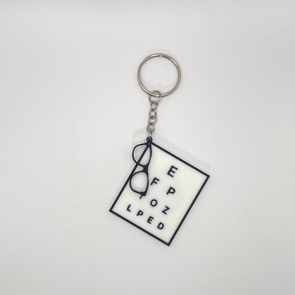 Keychain with eyeglasses and text on a white background