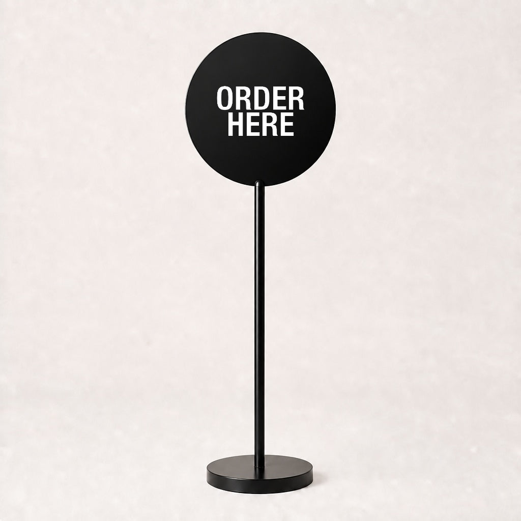 Black acrylic floor sign with ORDER HERE on the disc, example custom artwork