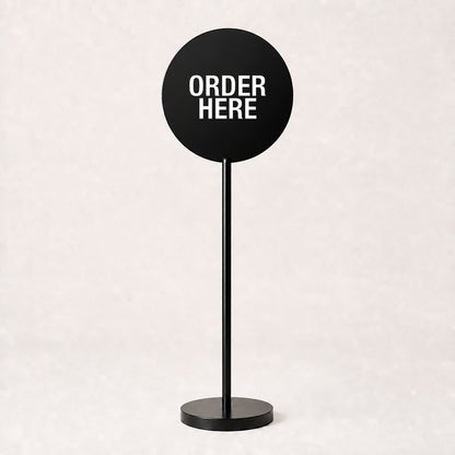 Black acrylic floor sign with ORDER HERE on the disc, example custom artwork