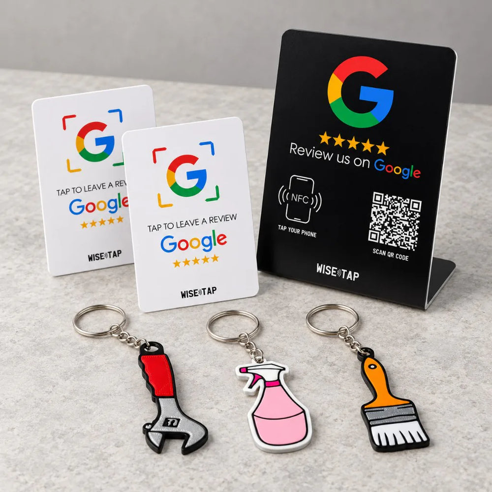 Trades Team Review Kit: three trade-shaped NFC keychains (wrench, cleaning spray, paint brush), two Google NFC review cards and a dark Google NFC stand on a counter