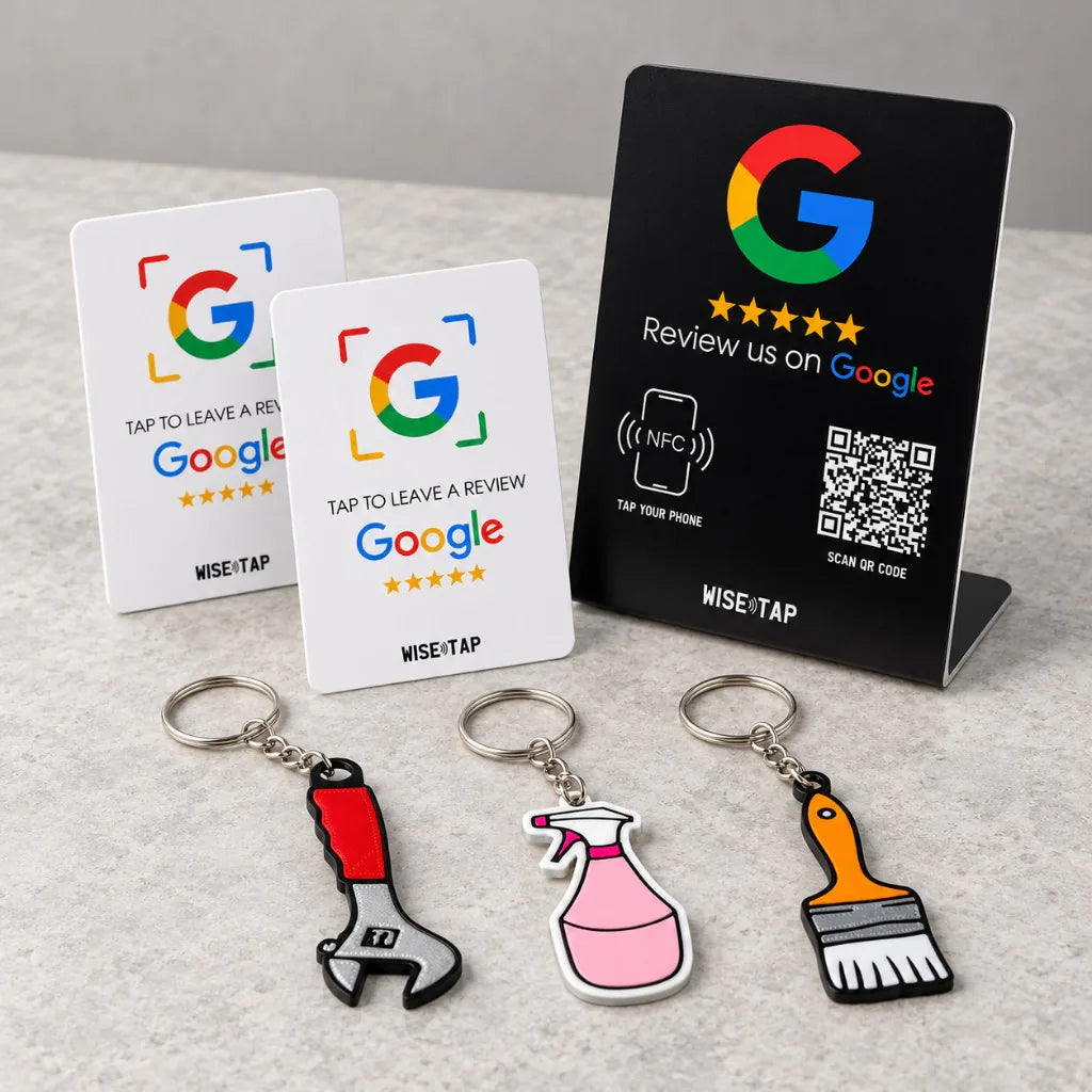 Trades Team Review Kit: three trade-shaped NFC keychains (wrench, cleaning spray, paint brush), two Google NFC review cards and a dark Google NFC stand on a counter